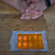 A pack of ketamine tablets is on a table in front of a patient's hands.